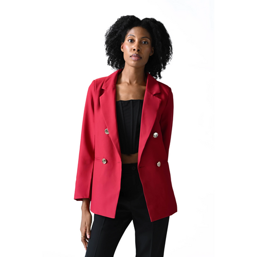 Woman wearing a red blazer over a black top on a white background