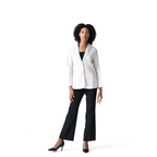Woman wearing a white blazer and black pants on a white background