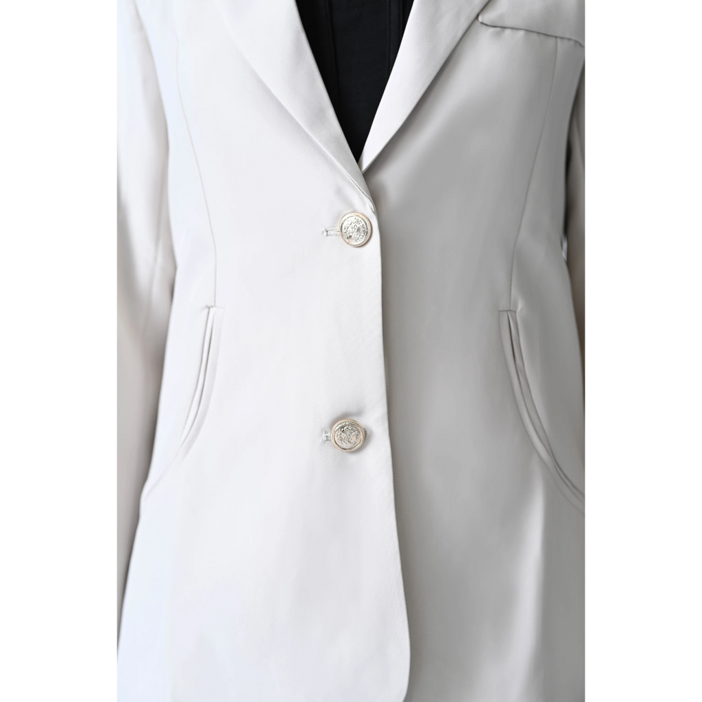 cream colored blazer with silver metallic buttons