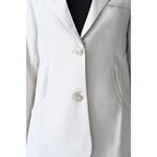 cream colored blazer with silver metallic buttons